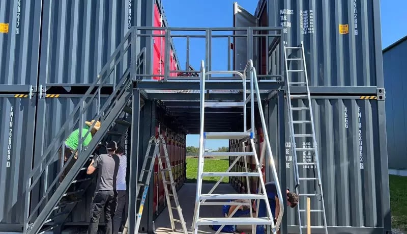 Workers constructing a two-story FOREMOST movable self storage container facility